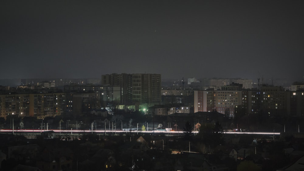 a city skyline at night with buildings lit up