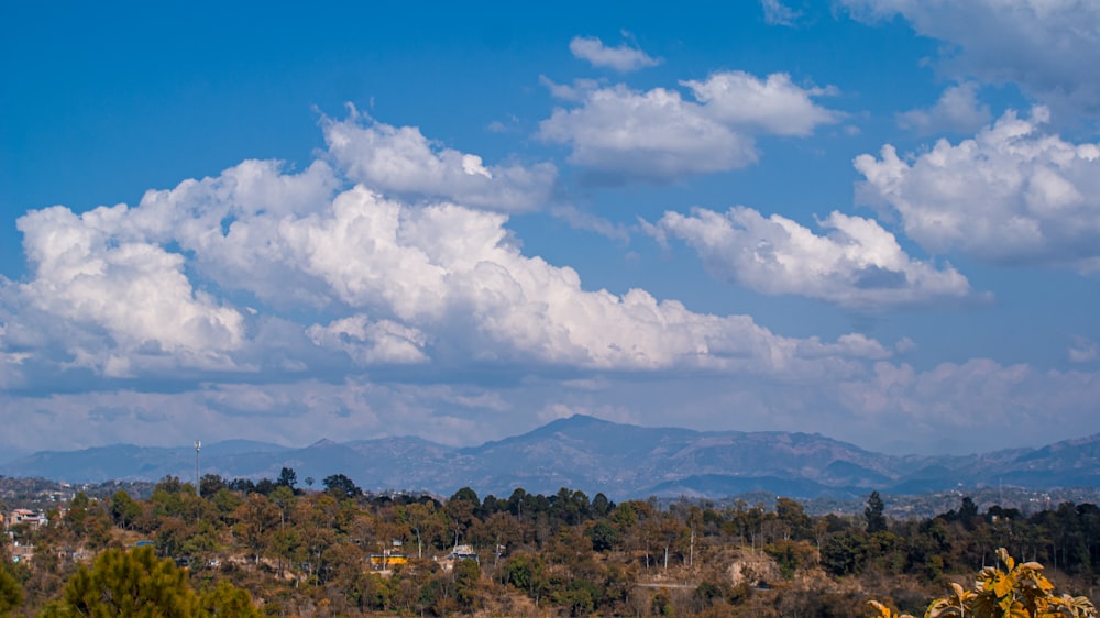 a view of a mountain range with clouds in the sky