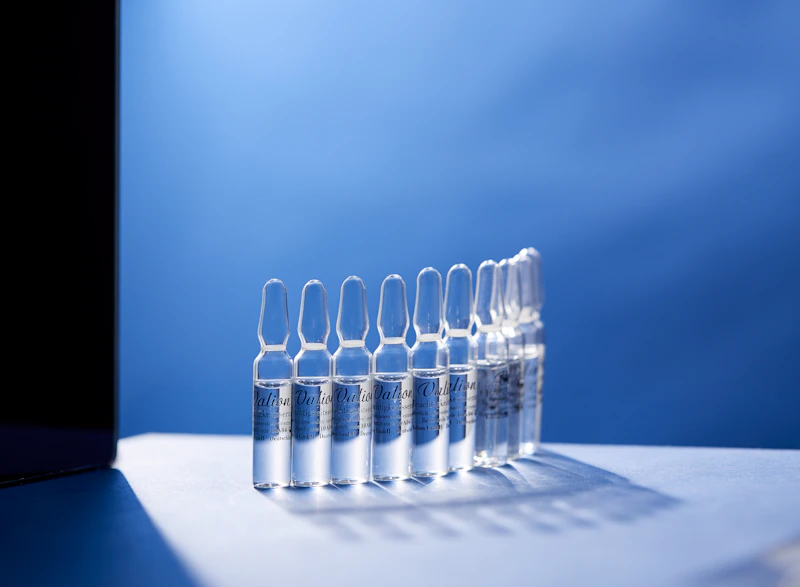 Row of blue-lit glass ampoules — 2–8°C biologics cold storage