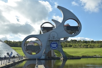 a large white sculpture sitting on top of a lake
