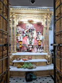 A serene altar adorned with golden offerings and candles dedicated to Mãe Oxum.