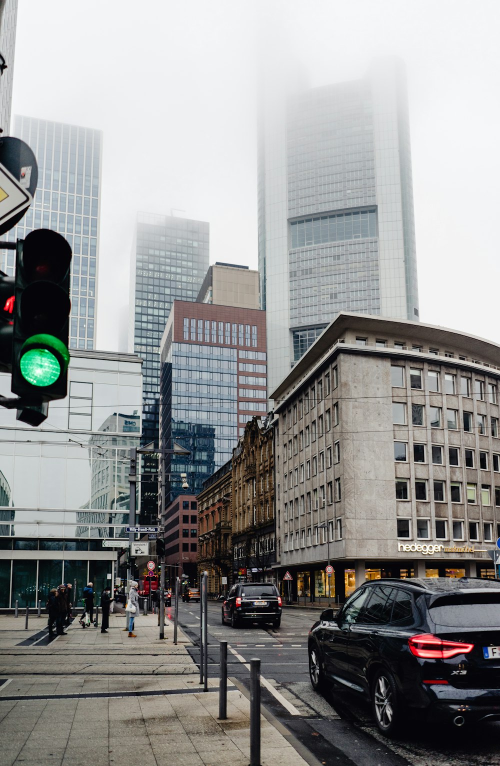 a city street filled with traffic and tall buildings