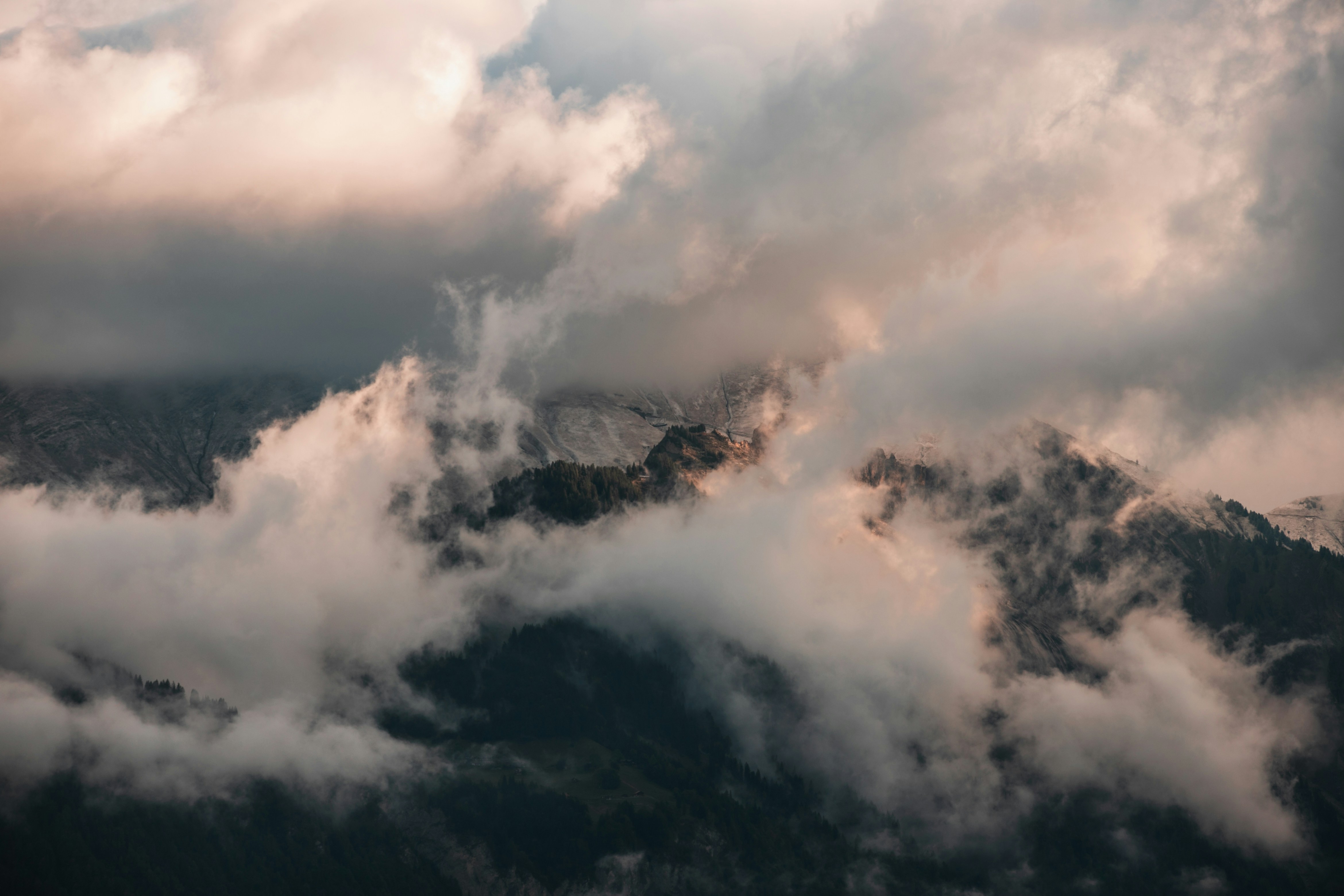 a view of a mountain range covered in clouds