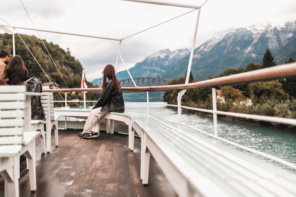 a woman sitting on a bench on a boat