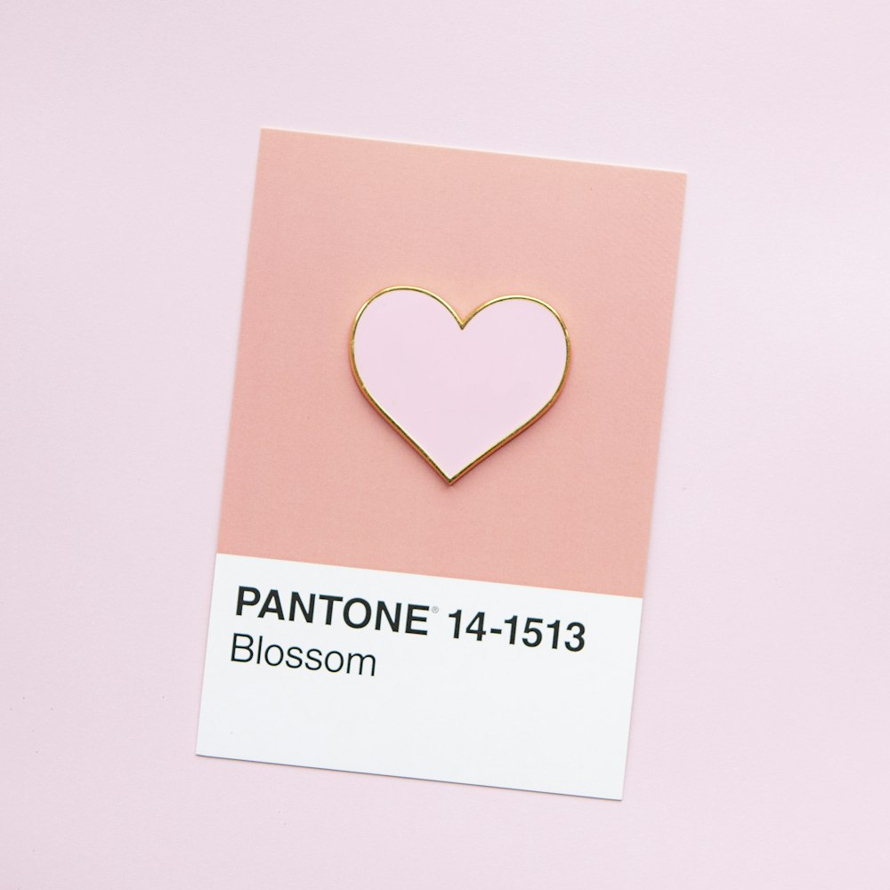 a pin with a pink heart on it