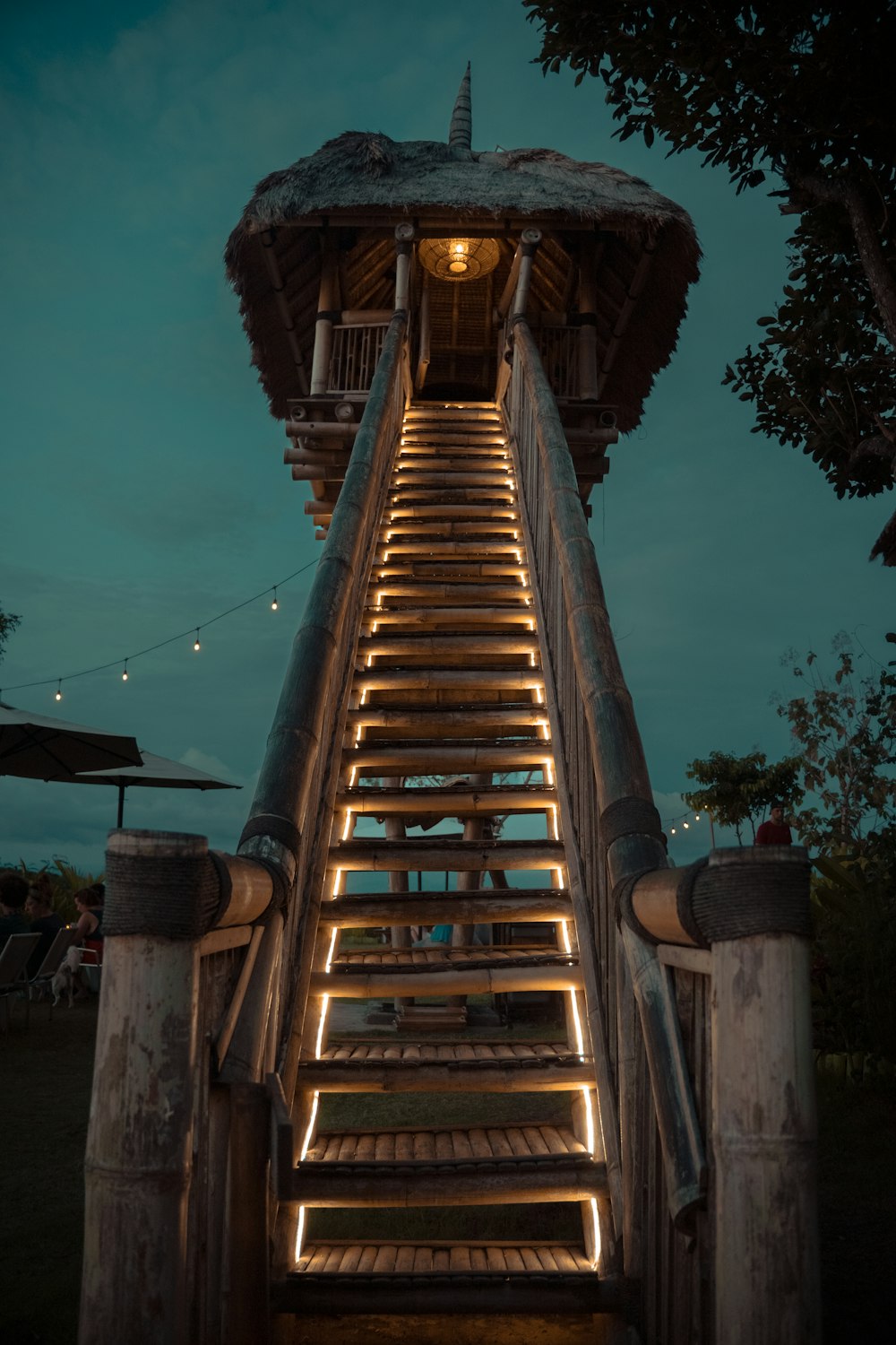 a wooden staircase lit up at night