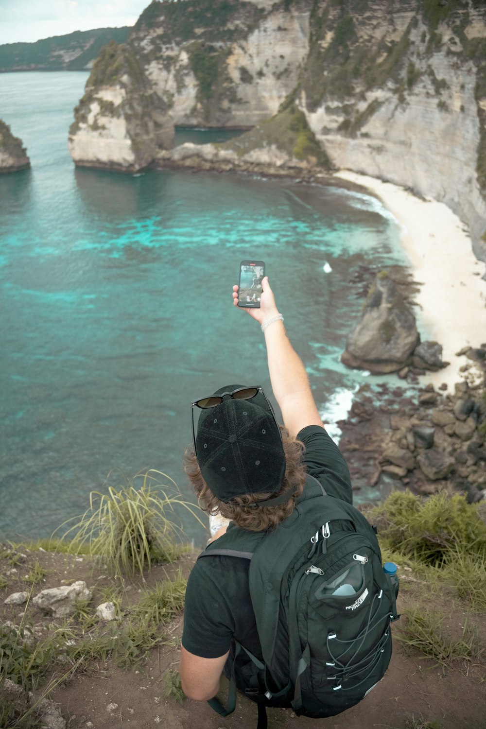 a person taking a picture of a body of water