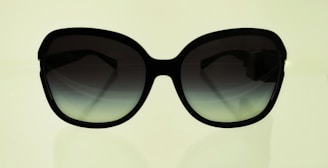 A pair of elegant sunglasses with a summer background.