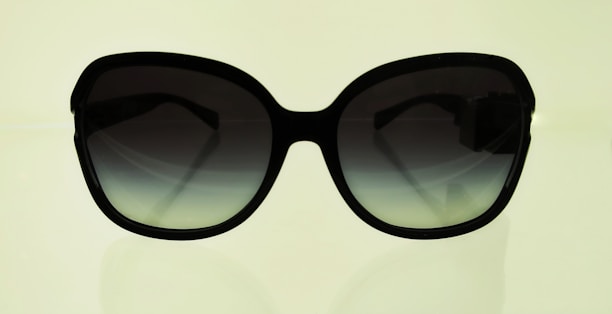 Sleek sunglasses displayed on a summer beach background