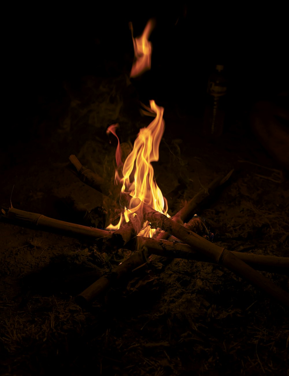 a fire burning in the dark with lots of sticks