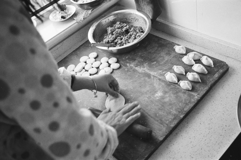 a black and white photo of a person preparing food