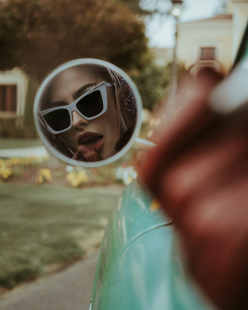 a woman with sunglasses is taking a picture of herself in the mirror