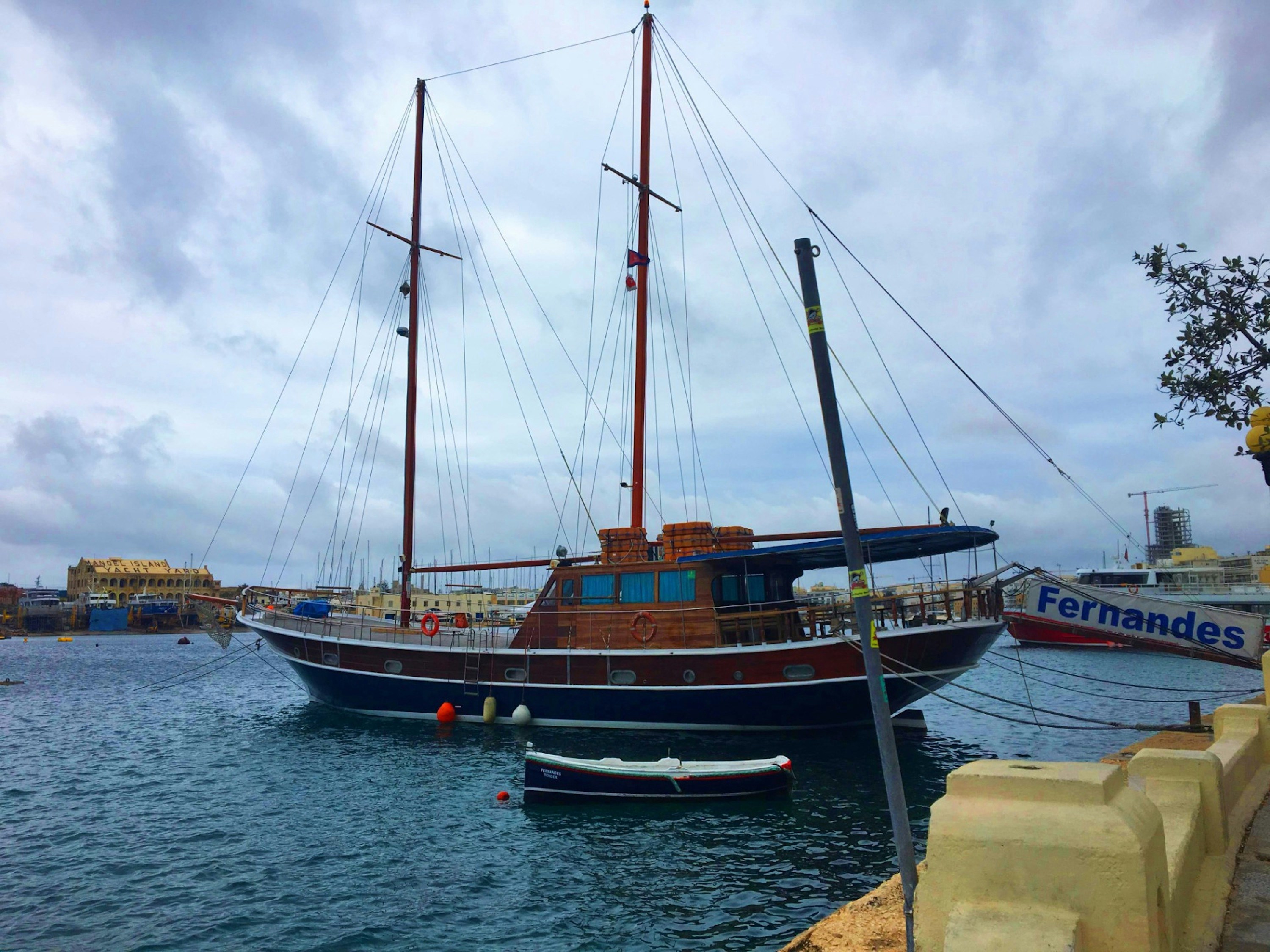 a boat is docked in a harbor with other boats
