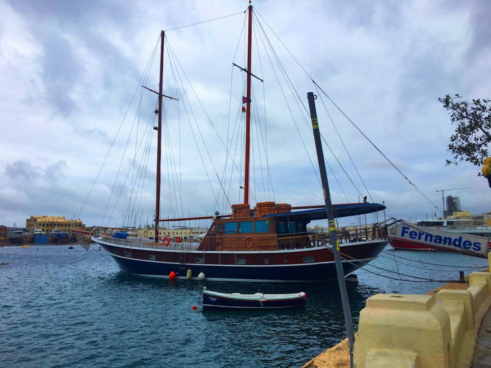 a boat is docked in a harbor with other boats