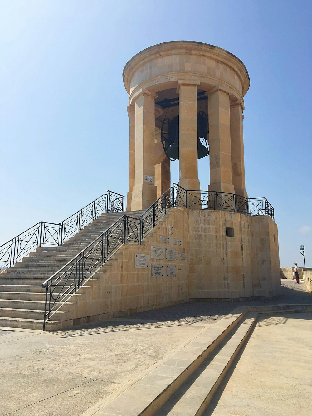 a stone structure with a bell on top of it