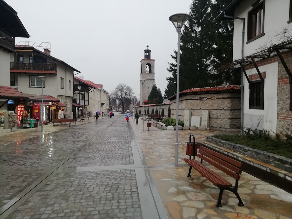 a city street with a clock tower in the background