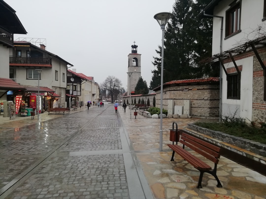 a city street with a clock tower in the background,