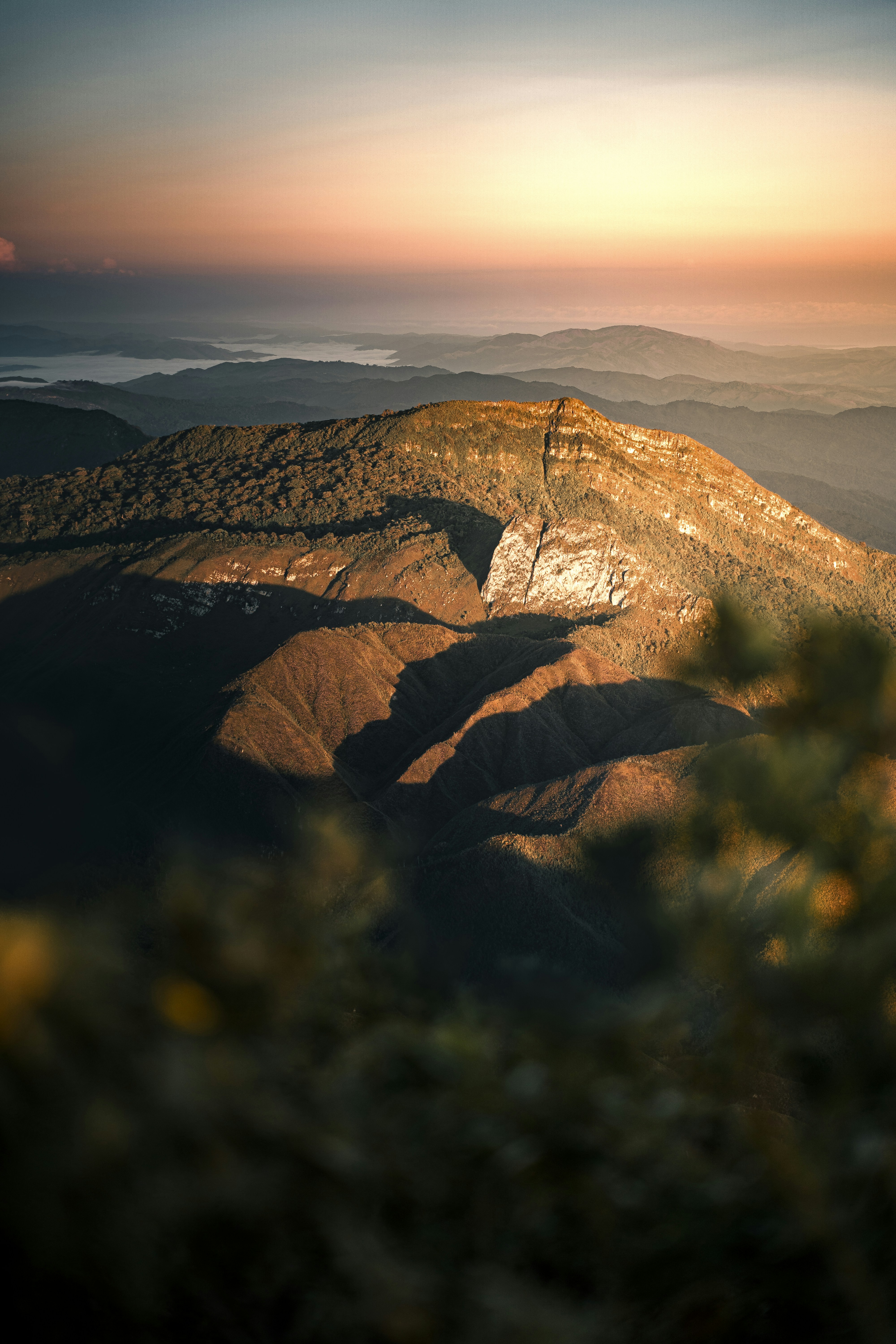 Sunrise casts light on a majestic mountain range.
