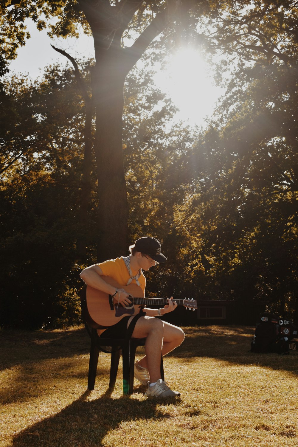 a woman sitting in a chair playing a guitar