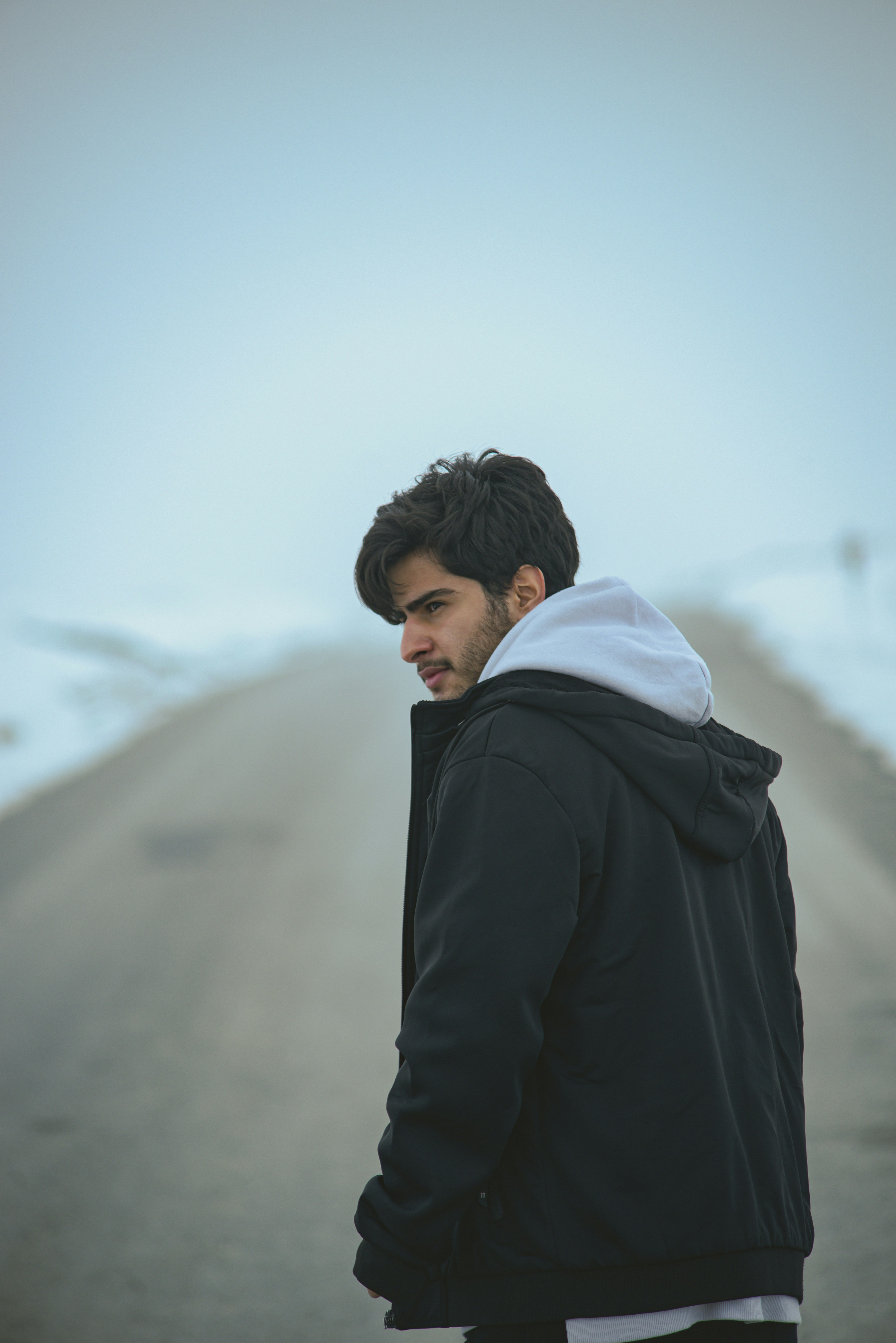 a man standing on the side of a road