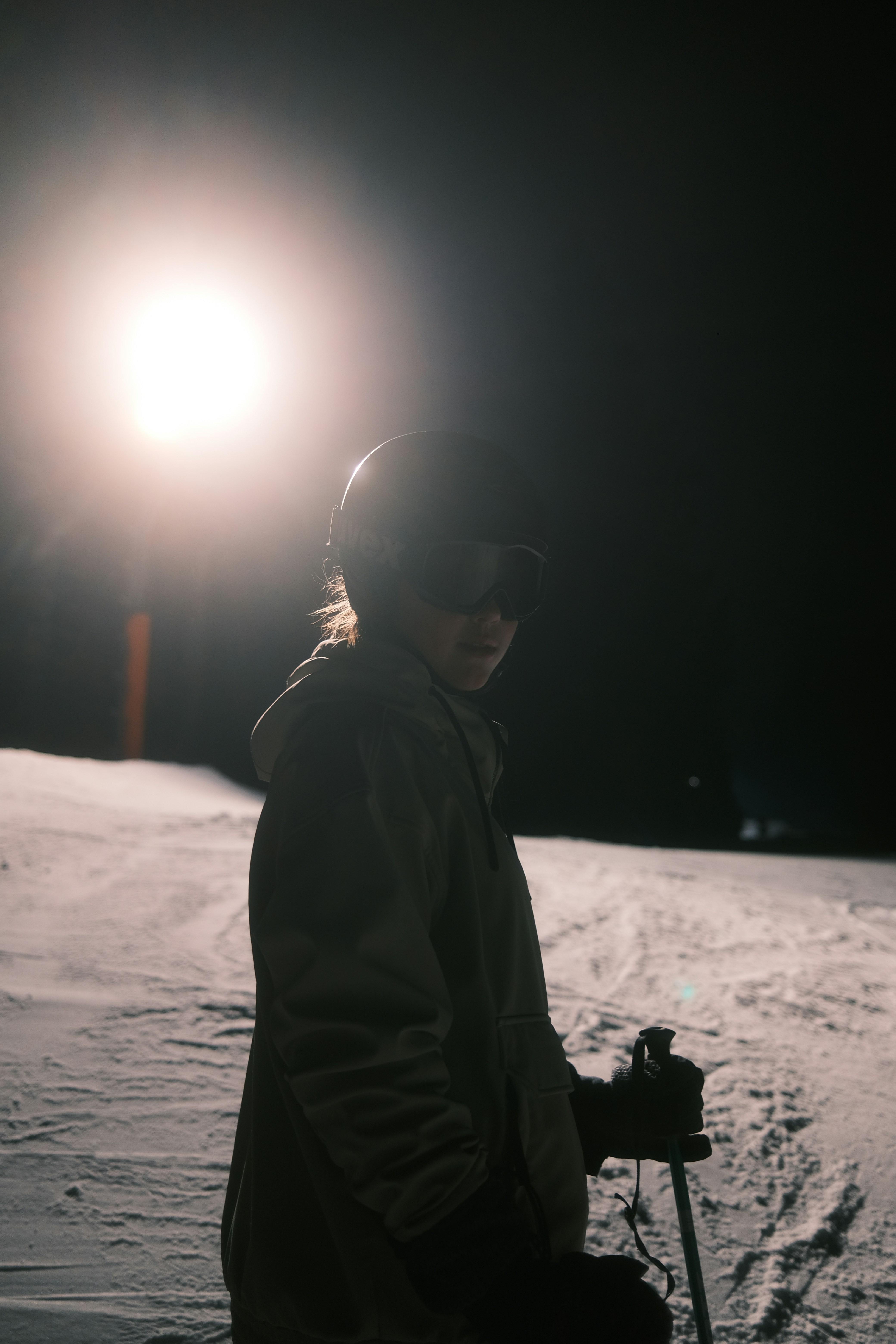 a person sitting in the snow at night