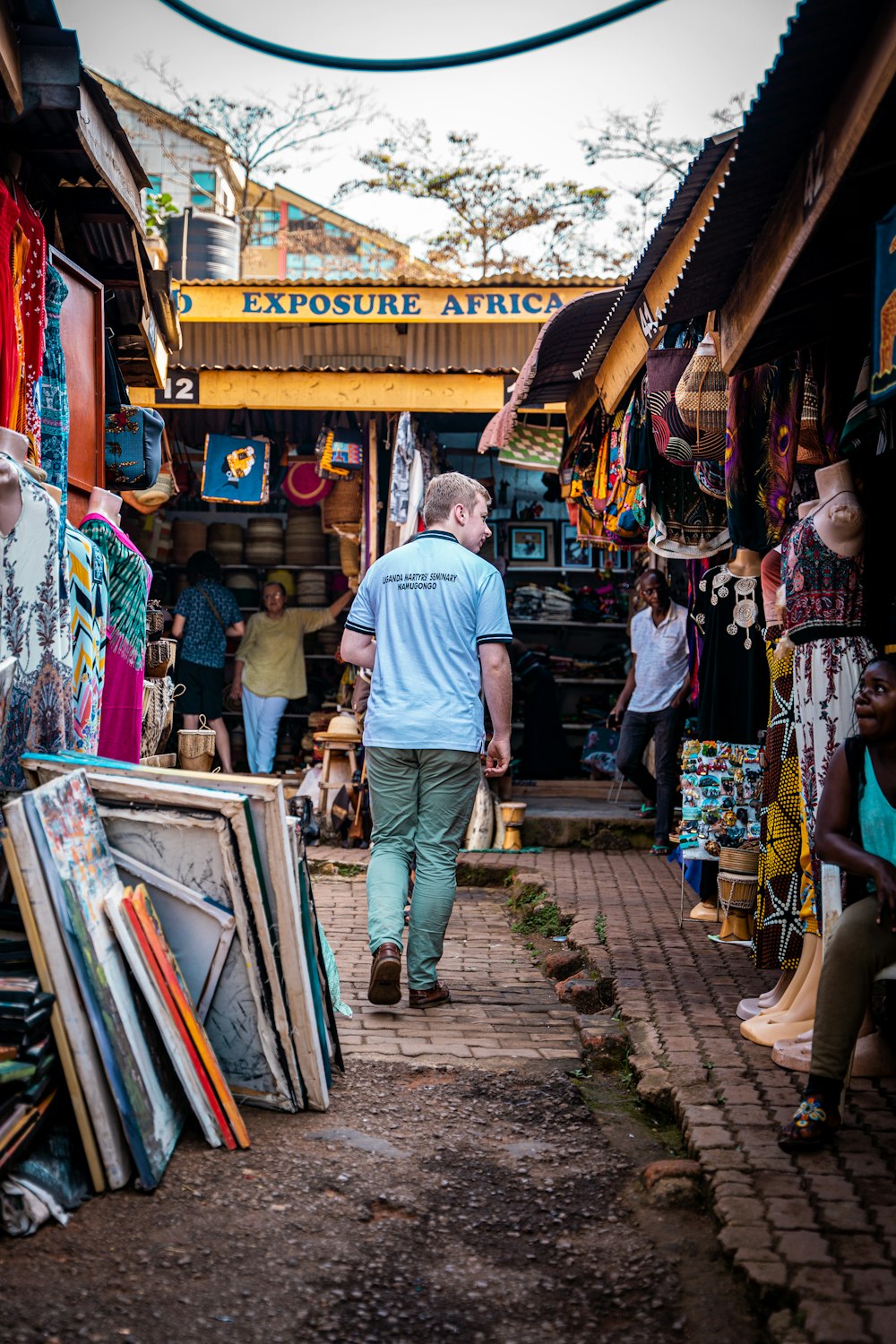 a man walking down a street next to a store