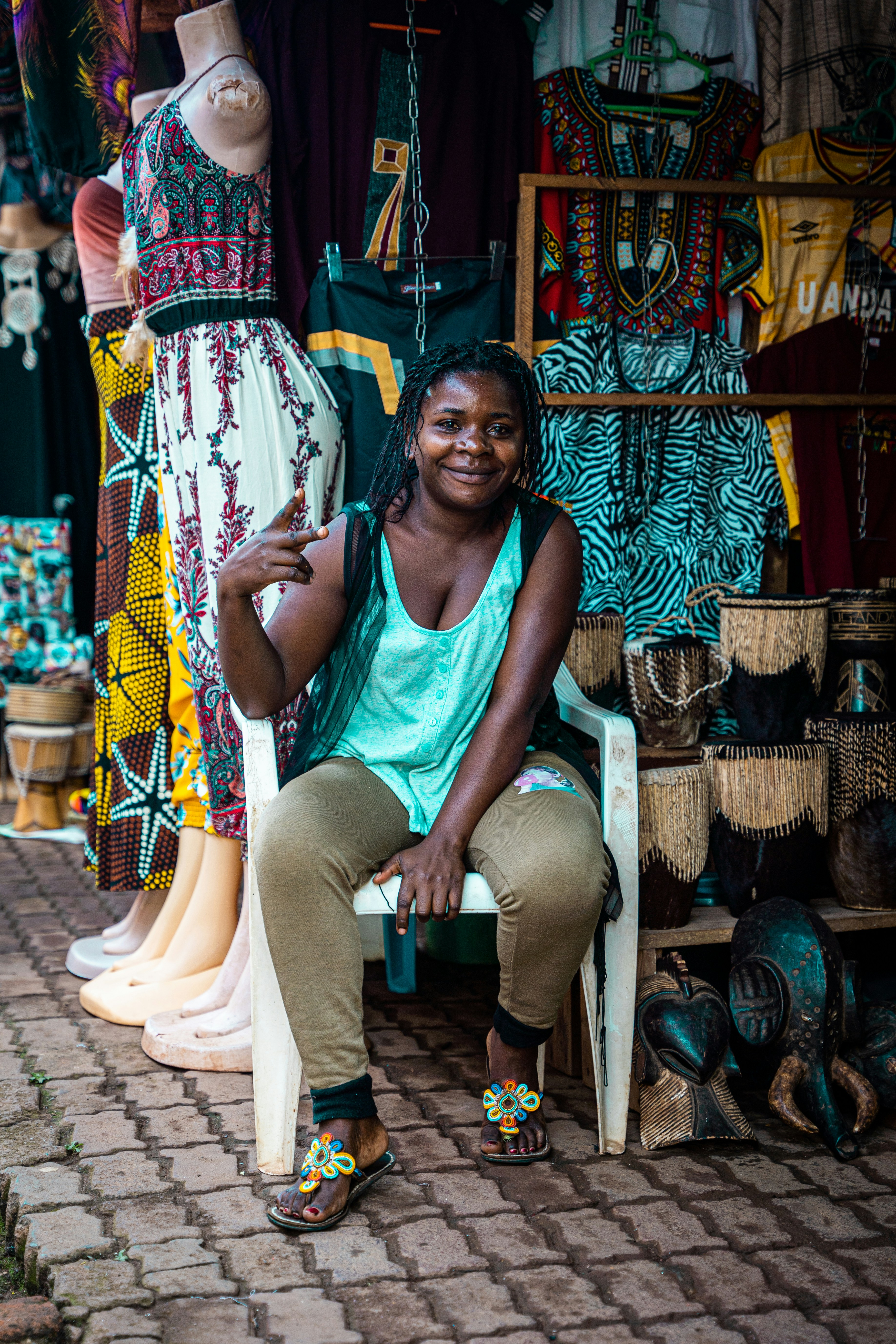 a woman sitting on a chair in front of a store