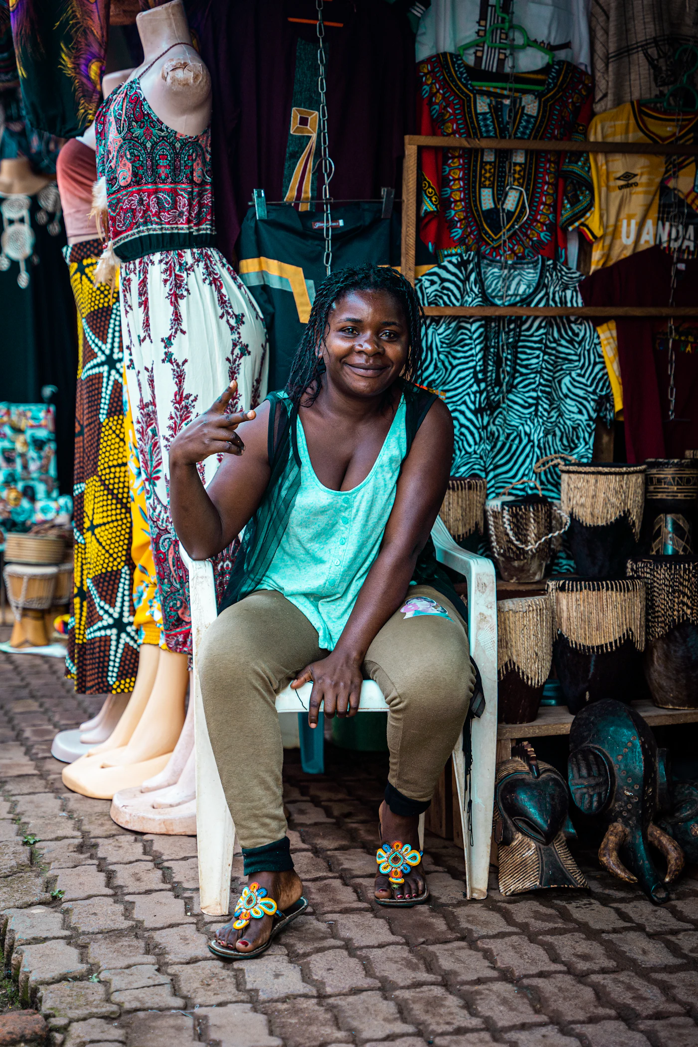 A woman sitting on a chair in front of a store