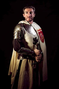 A dark medieval-modern gaming interface with golden accents showing knights wielding swords and a glowing microphone icon.