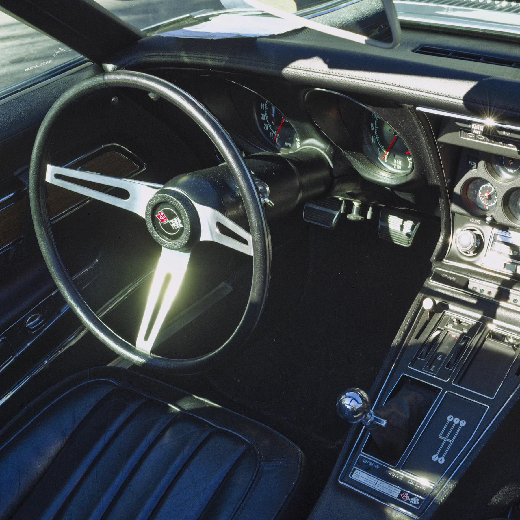 Black automotive cabin with steering wheel and leather seat