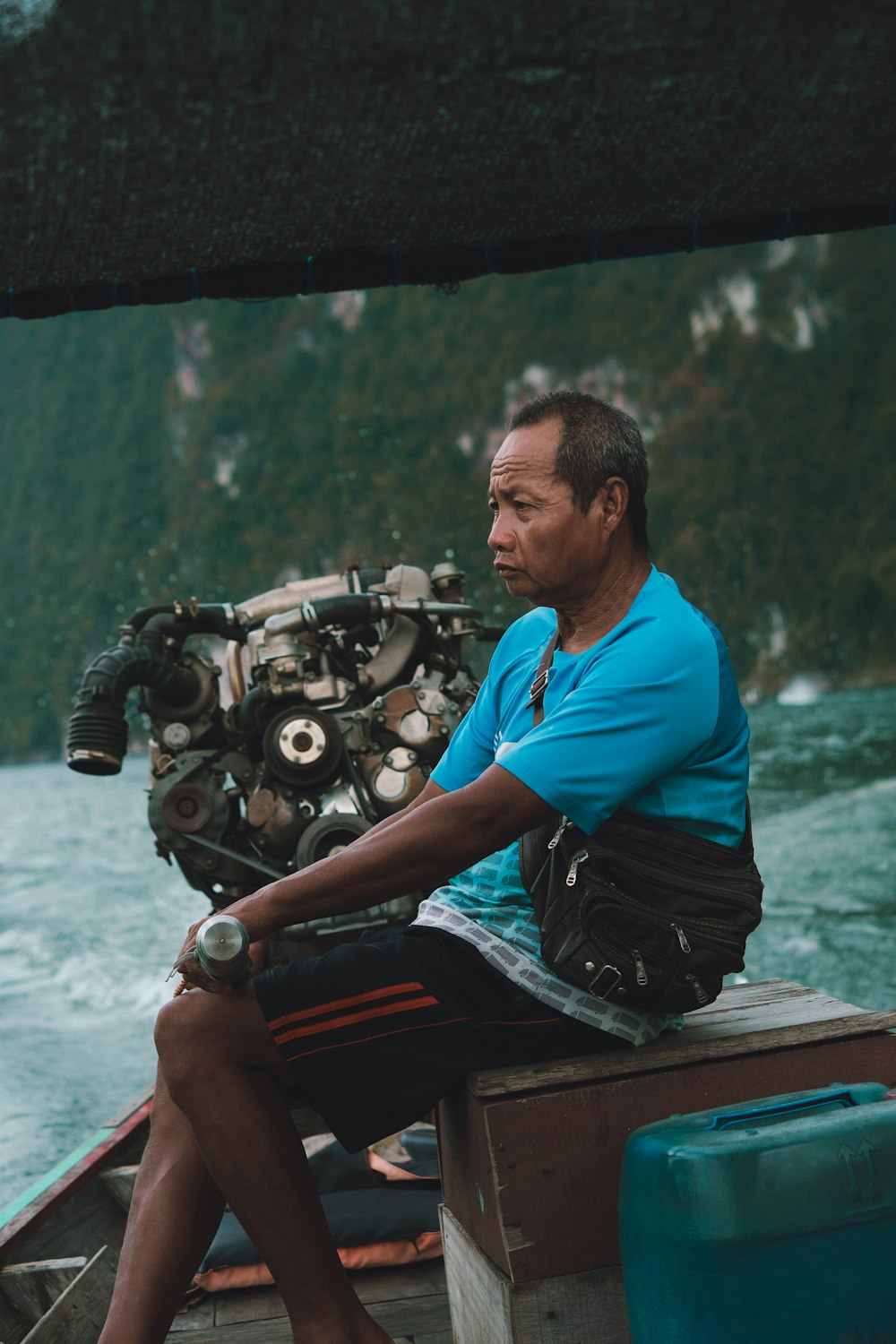 a man sitting on a boat in the water