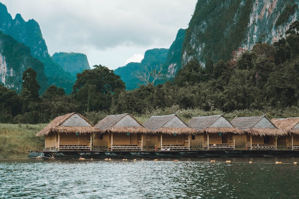 a row of huts sitting on top of a body of water