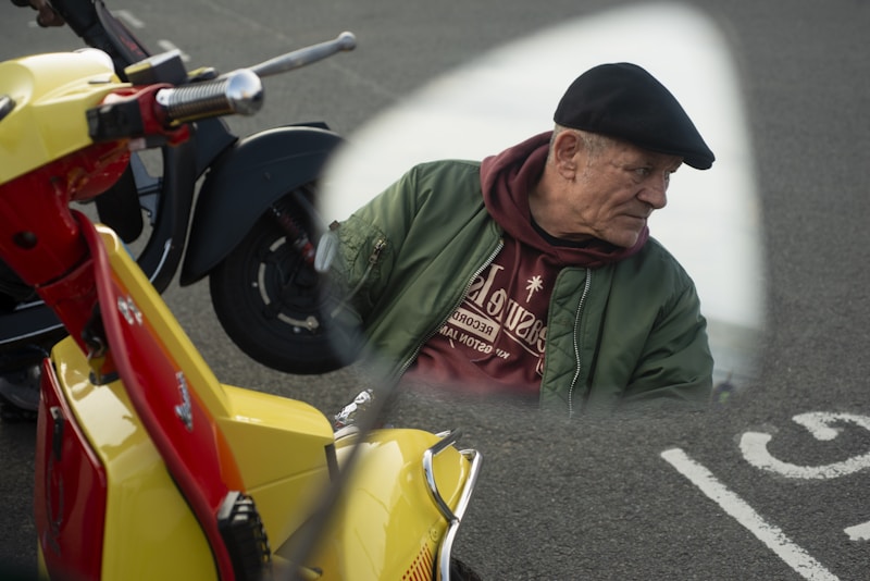Mature man posing with a classic scooter