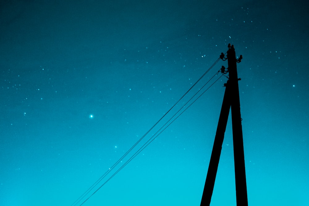 a telephone pole with a sky in the background
