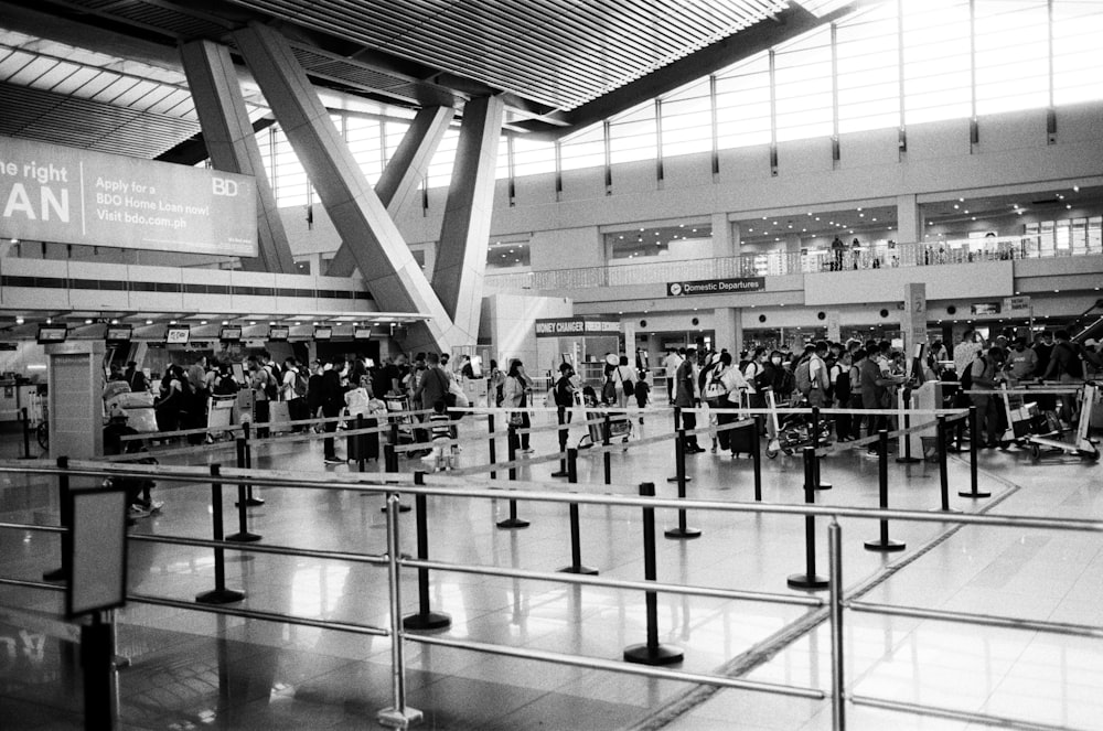 a black and white photo of people at an airport