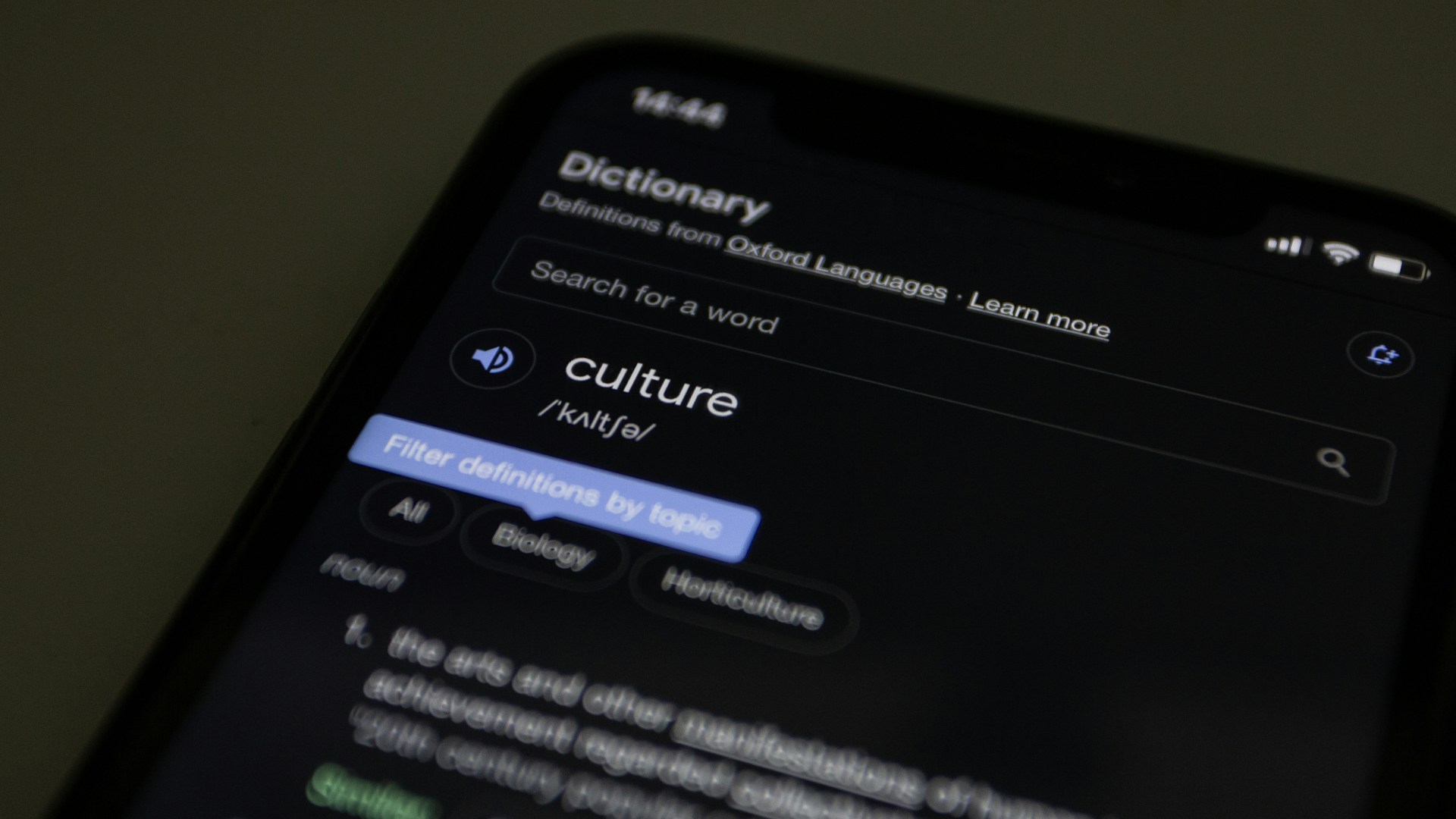 a close up of a cell phone with a dictionary on the screen