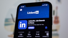 the linkedin logo is displayed on a smartphone