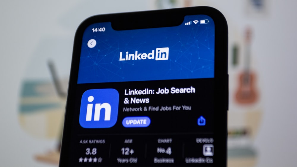 the linkedin logo is displayed on a smartphone