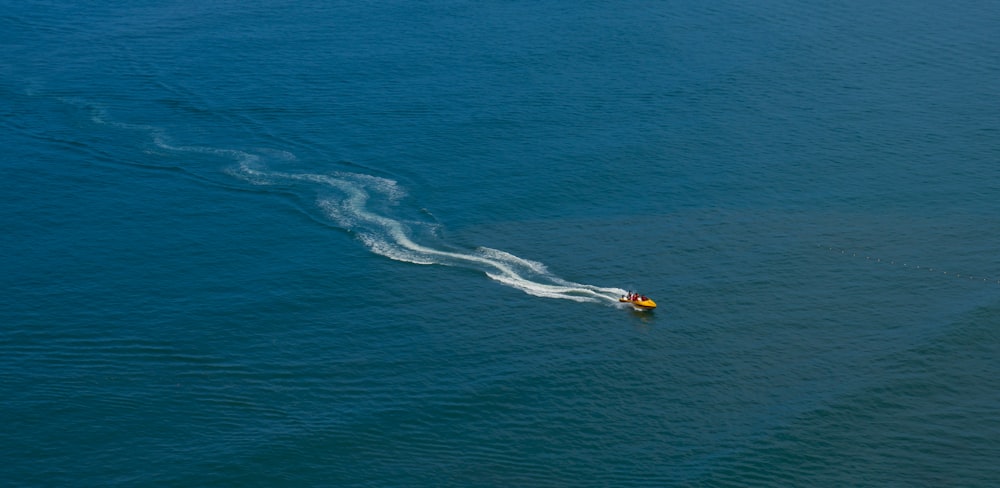 a small boat in the middle of a body of water