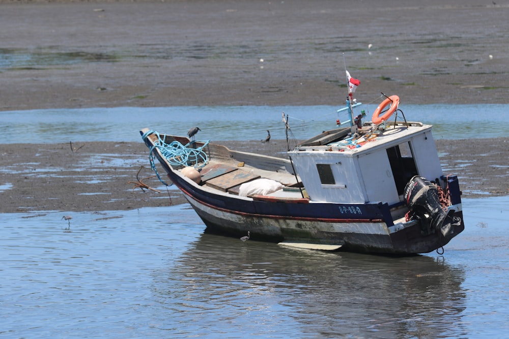 a small boat sitting on top of a body of water