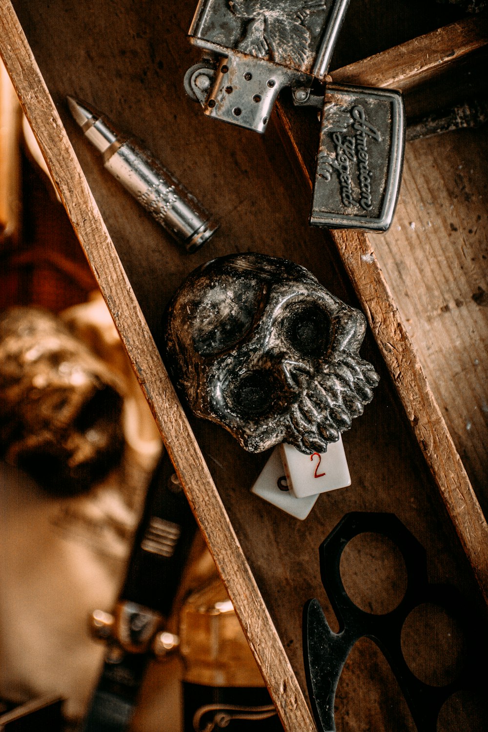 a wooden table topped with a skull and a pair of scissors