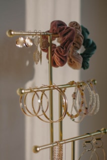 a gold jewelry rack with several pairs of earrings on it