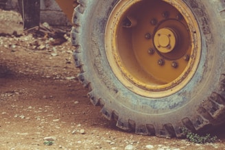 a close up of a yellow wheel on a truck