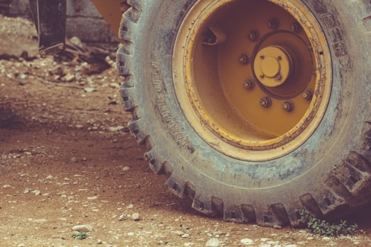 a close up of a yellow wheel on a truck