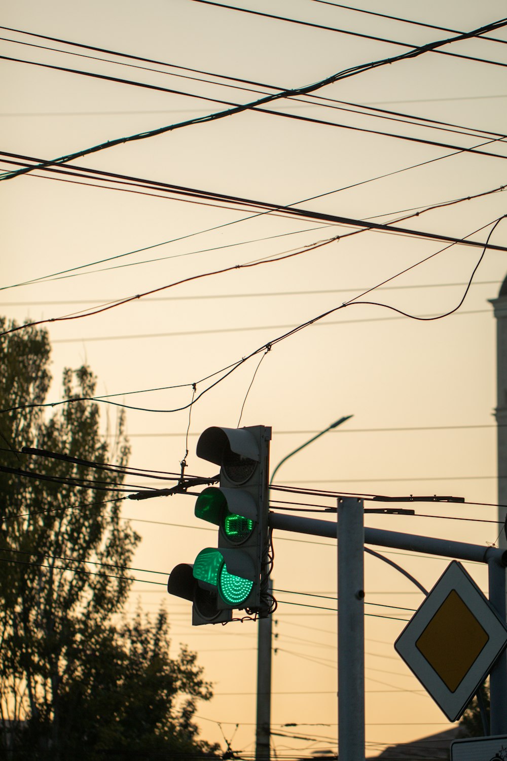 a traffic light hanging over a street next to power lines