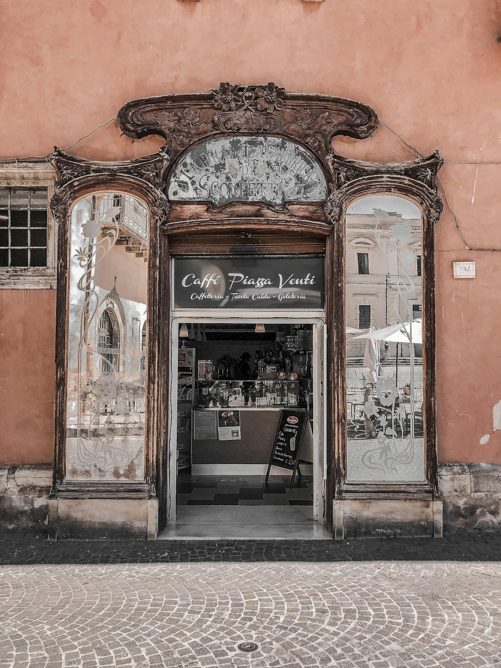 a building with a store front and a clock on the front of it