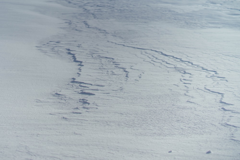 a person riding skis down a snow covered slope