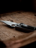 A sturdy survival knife resting on a wooden surface.