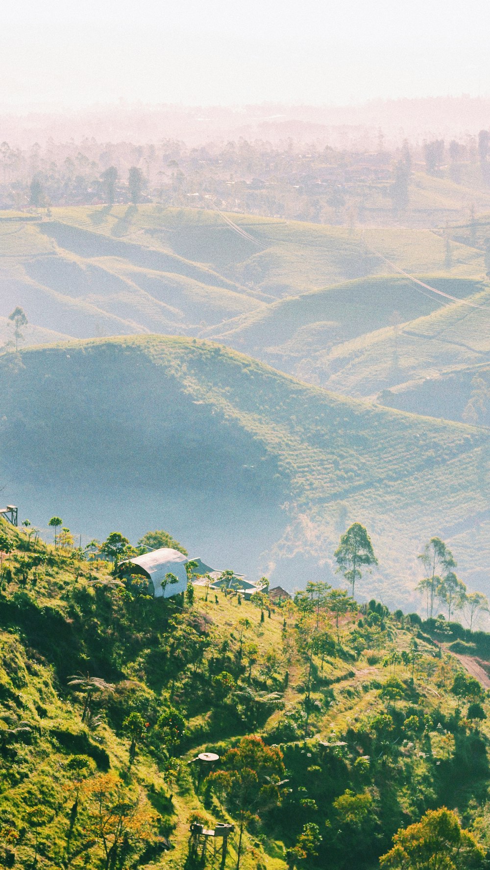 a view of a hill with a house on top of it