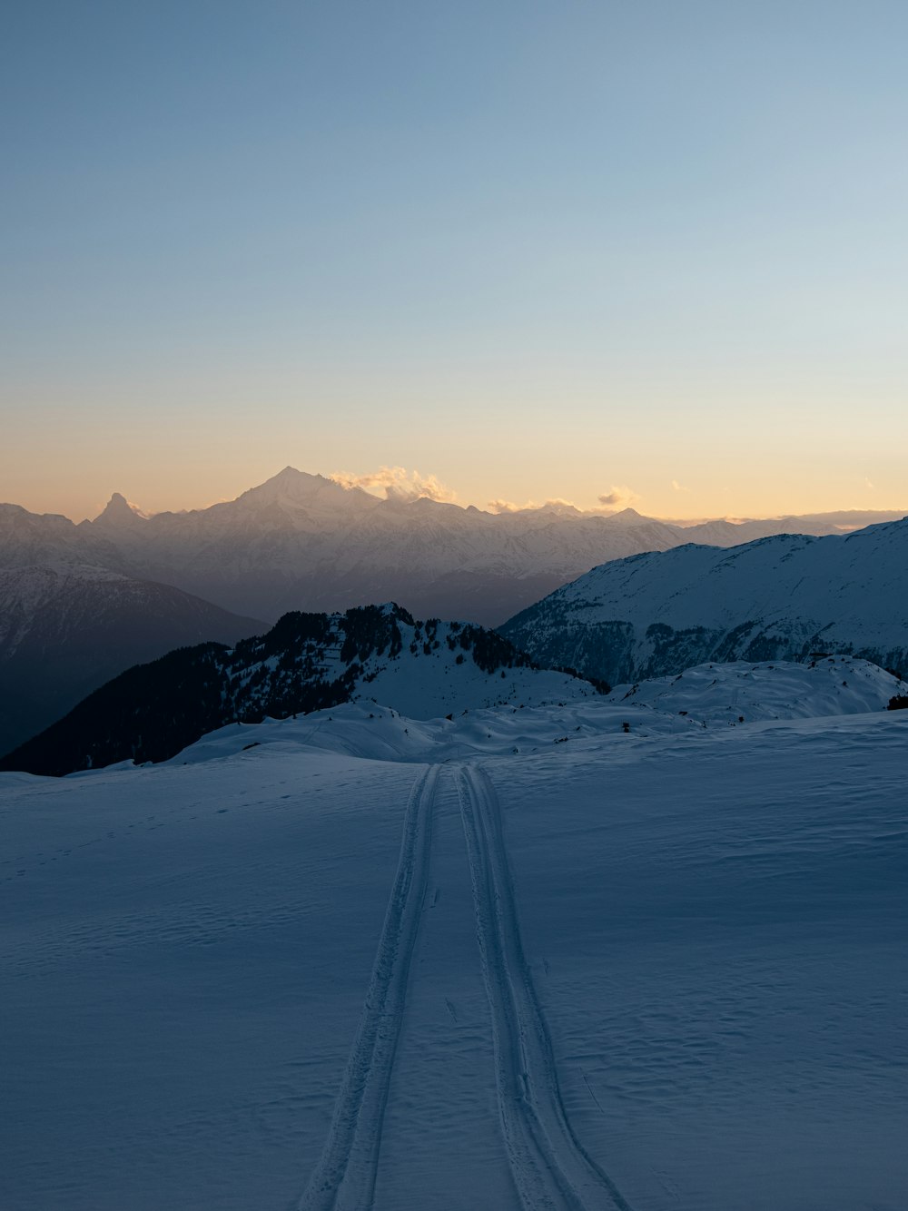 a person riding skis on top of a snow covered slope